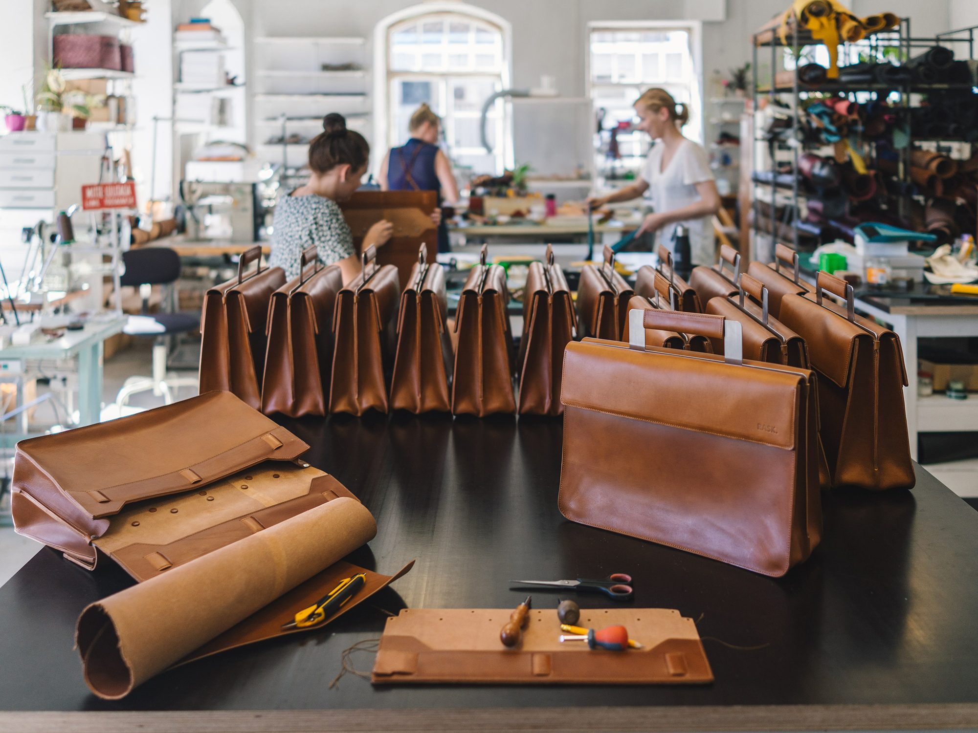 Leather bags in progress on a workbench in the Stella Soomlais studio