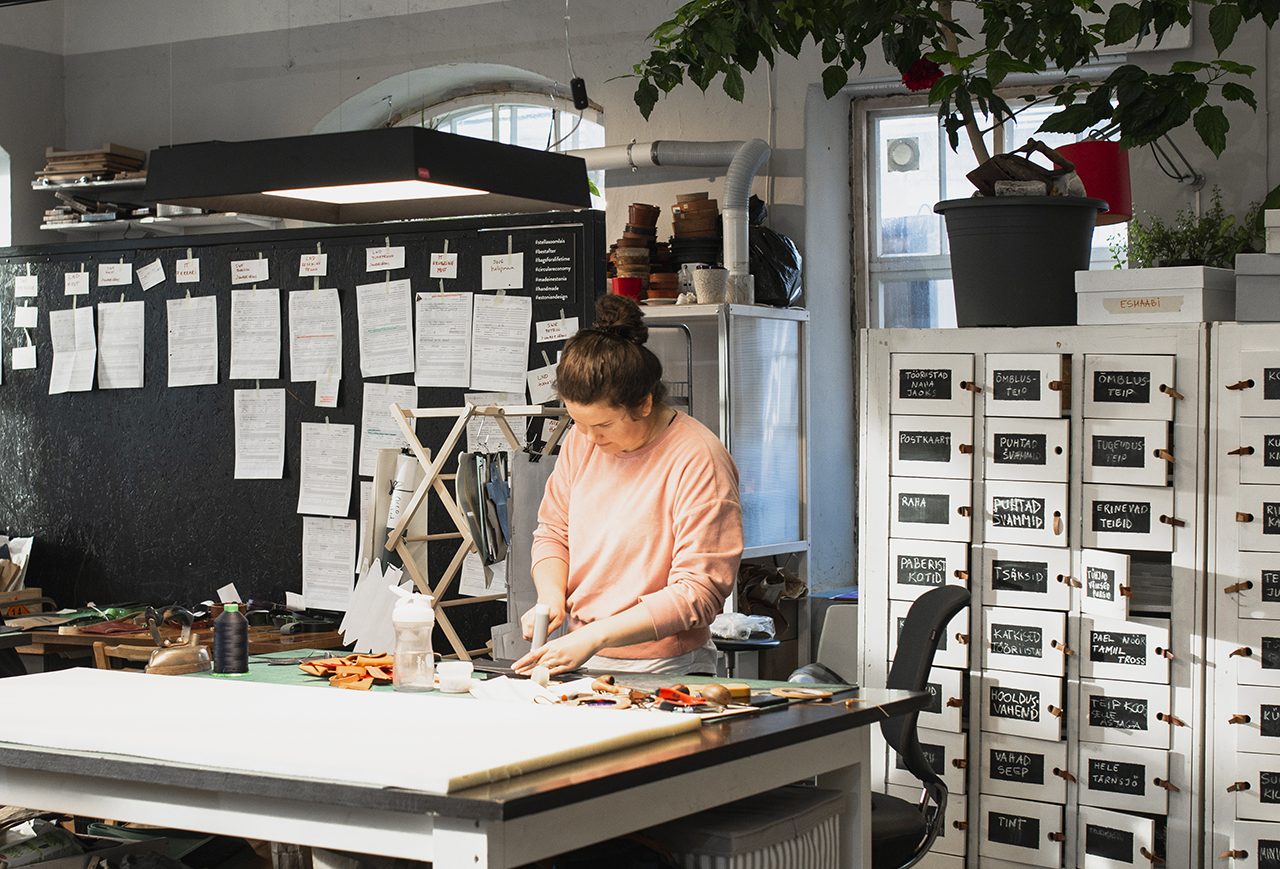 A crafter working at a bench in the Telliskivi studio