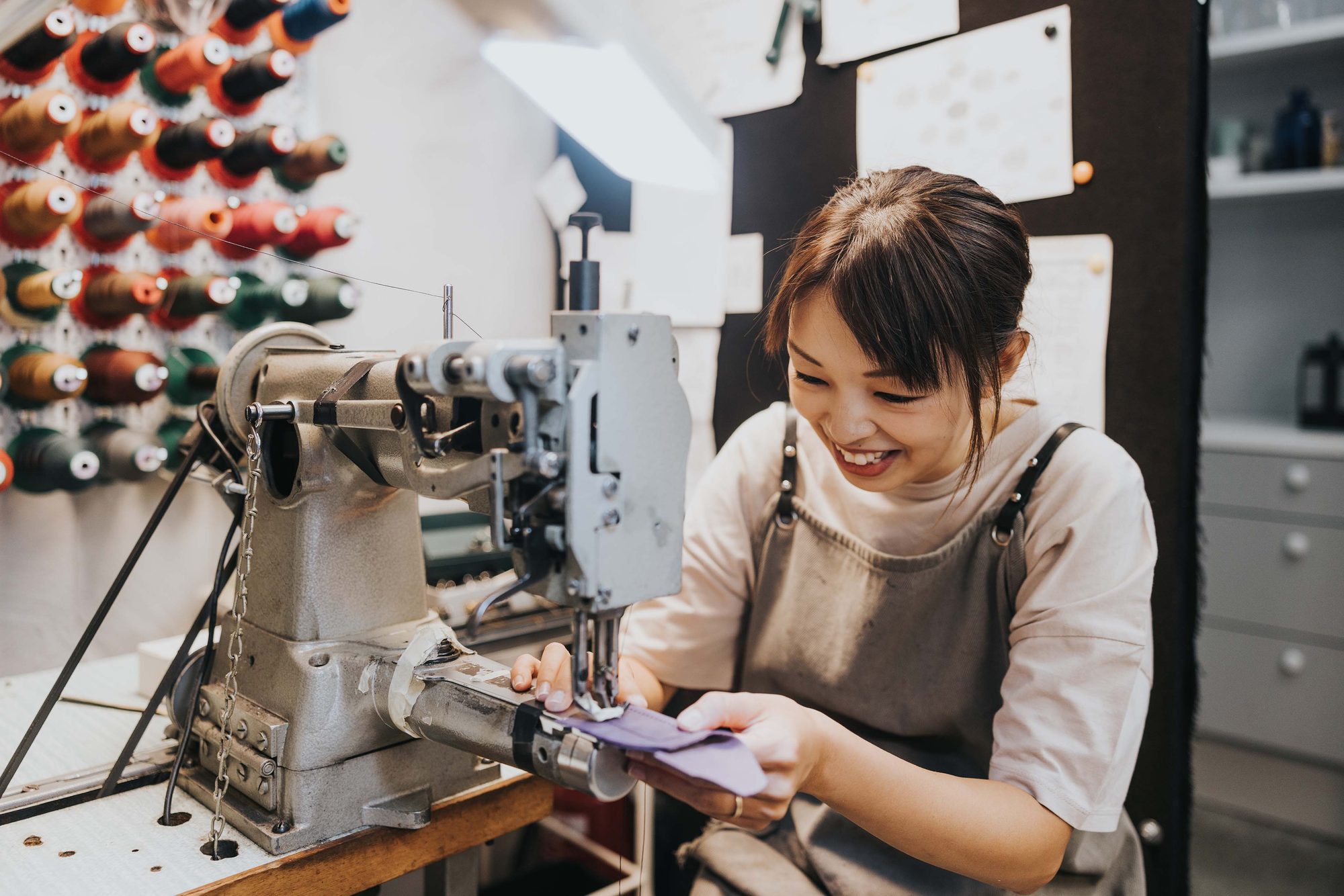 A participant at a sewing machine during a team workshop